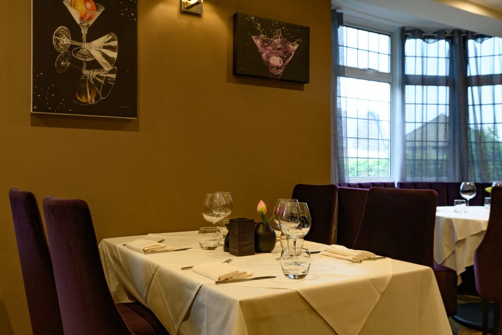 Table for two by the window in the dining room at The Gables