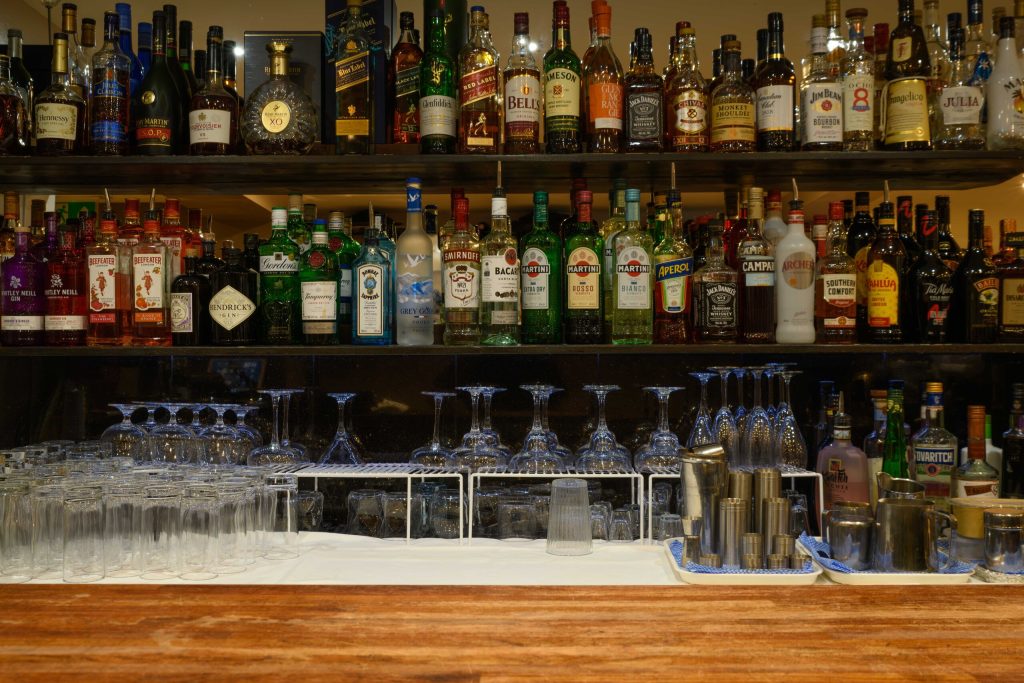 Well-stocked cocktail bar with spirits and glassware at The Gables